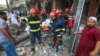 Firefighters move the body of a victim after an explosion in a building in Dhaka, Bangladesh, March 7, 2023. 