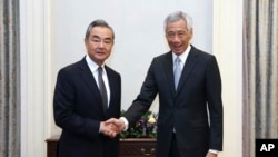 Chinese Foreign Minister Wang Yi, left, meets with Singapore's Prime Minister Lee Hsien Loong in Singapore on Aug. 11, 2023. (Ministry of Communications and Information photo via AP)