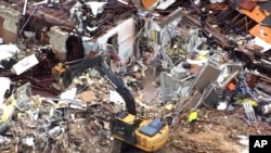 FILE - A crew clears debris caused by a tornado in Sulphur, Oklahoma, April 28, 2024, in this image taken from video provided by KOCO.