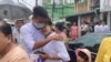 FILE - A man is welcomed by his mother after his release from Insein Prison in Yangon, Myanmar, May 3, 2023. VOA Burmese says there are still about 40 journalists locked up in prisons across the country.