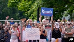 Supports hold signs before Vice President Kamala Harris arrives to deliver remarks at a campaign event in Pittsfield, Mass., July 27, 2024.