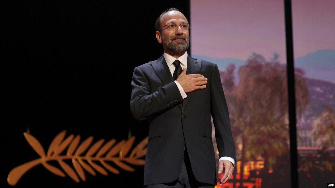 FILE - Iranian film director and member of the Jury of the Official Selection Asghar Farhadi arrives on stage during the Closing Ceremony of the 75th edition of the Cannes Film Festival in Cannes, southern France, May 28, 2022.