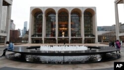 FILE - The Metropolitan Opera house, background center, appears at Lincoln Center in New York on March 12, 2020.