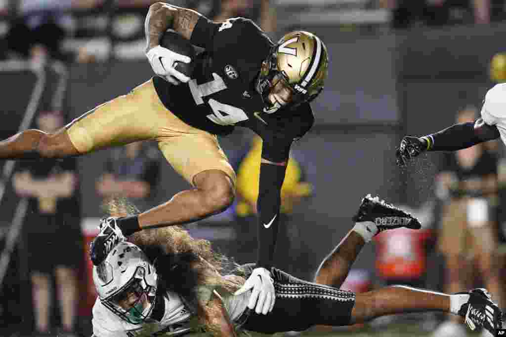Vanderbilt wide receiver Will Sheppard (14) is stopped by Hawaii defensive back Peter Manuma during the second half of an NCAA college football game, Aug. 26, 2023, in Nashville, Tennessee.