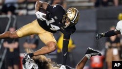 FILE - Vanderbilt wide receiver Will Sheppard (14) is stopped by Hawaii defensive back Peter Manuma during the second half of an NCAA college football game, Aug. 26, 2023, in Nashville, Tenn.