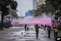 FILE - Police fire water canons during a protest in Nairobi, Kenya, July 16, 2024. Police hurled tear gas canisters to break up protests in Nairobi and other major cities accusing the president of poor governance and calling for his resignation.