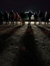 FILE - Migrants wait to be processed to seek asylum after crossing the border into the United States, Jan. 6, 2023, near Yuma, Ariz.