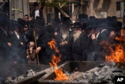 FILE—Ultra-Orthodox Jewish men and children burn leavened items in final preparation for the Passover holiday in the ultra-Orthodox Jewish town of Bnei Brak, near Tel Aviv, Israel, April 22, 2024.