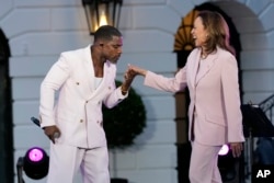 Gospel singer Kirk Franklin dances with Vice President Kamala Harris during a Juneteenth concert on the South Lawn of the White House in Washington, June 10, 2024.