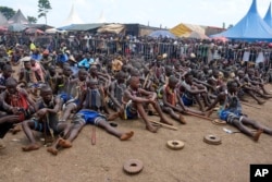 Young men are prepared for they traditional circumcision ritual, known as Imbalu, at Kamu village in Mbale, Eastern Uganda, Aug. 3, 2024.