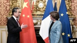 China's top diplomat Wang Yi is welcomed by French Foreign and European Affairs Minister Catherine Colonna ahead of their meeting in Paris, Feb. 15, 2023. 