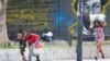 People take cover from gunfire near the National Palace, in Port-au-Prince, Haiti, March 21, 2024. 