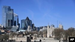 FILE - The Tower of London with the backdrop of the City of London, on March 24, 2020. 