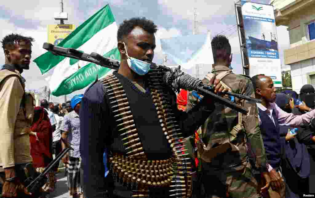 A Somali police officers stands guard during a march against the Ethiopia-Somaliland port deal along KM4 street in Mogadishu.