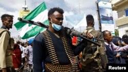 A Somali police officers stands guard during a march against the Ethiopia-Somaliland port deal along KM4 street in Mogadishu.