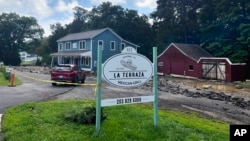 The driveway washed away and the basement flooded of Terraza Mexican Grill, owned by Isabel Perez, Javier Santos, in Oxford, Conn., when The Little River overflowed during heavy rains early Aug. 19, 2024, and the night before.