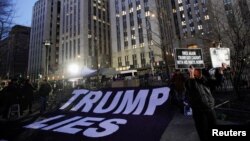 A giant sign is seen displayed outside Manhattan Criminal Court after former President Donald Trump's indictment by a grand jury in New York, March 30, 2023.