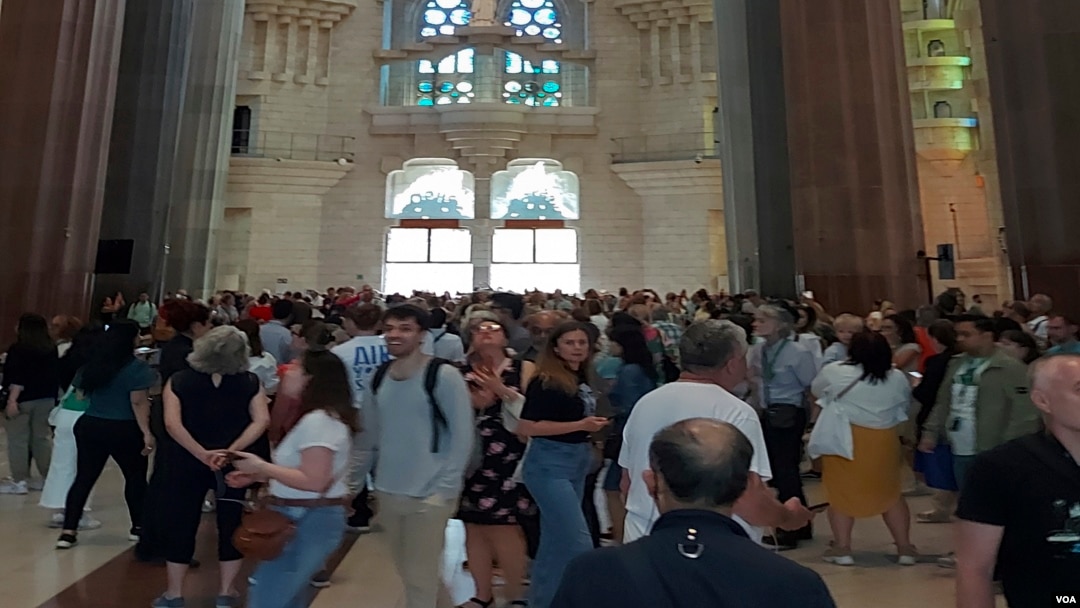 Visitors look around the main temple of the Sagrada Familia, Oct. 6, 2023. (Graham Keeley/VOA)