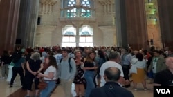Visitors look around the main temple of the Sagrada Familia, Oct. 6, 2023. (Graham Keeley/VOA)