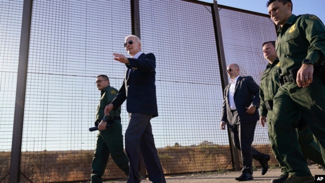 FILE - President Joe Biden walks along a stretch of the U.S.-Mexico border in El Paso Texas, Jan. 8, 2023.