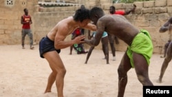 Shogo Uozumi, also known as Songo Tine, 29 years old, wrestles with Baye Ibra at the Samba Dia stable in the Diakhao neighbourhood, in Thies, Senegal, May 26, 2023. (REUTERS/Ngouda Dione)