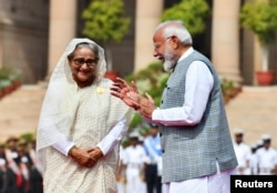 India's Prime Minister Narendra Modi speaks with Bangladesh's Prime Minister Sheikh Hasina during her ceremonial reception at the Forecourt of India's Rashtrapati Bhavan Presidential Palace, in New Delhi, June 22, 2024.