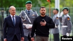 Ukraine's President Volodymyr Zelenskiy gestures as German Chancellor Olaf Scholz welcomes him at the Chancellery in Berlin, Germany, May 14, 2023.