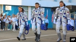 Crew members NASA astronaut Loral O'Hara, left, Roscosmos cosmonauts Oleg Kononenko, center, and Nikolai Chub, walk prior the launch of Soyuz MS-24 space ship at Baikonur cosmodrome, Kazakhstan, Sept. 15, 2023. (Roscosmos space corporation, via AP)
