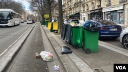 Trash clutters a bike lane in the city's 12th arrondissement. (Lisa Bryant/VOA)