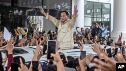 FILE- Prabowo Subianto greets supporters during a campaign rally in Medan, North Sumatra, Indonesia, Jan. 13, 2024. Subianto has been confirmed, March 20, 2024, as the victor of last month's presidential election over two former governors.
