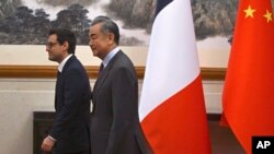 France's Minister for Foreign and European Affairs Stephane Sejourne, left, and China's Foreign Minister Wang Yi walk after shaking hands during a meeting at the Diaoyutai State Guest House in Beijing, April 1, 2024.