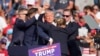 Republican presidential candidate former President Donald Trump is helped off the stage at a campaign event in Butler, Pennsylvania, July 13, 2024.