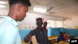 A voter casts his ballot during the parliamentary election in Djibouti city on Feb. 24, 2023.