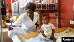 A nurse cares for an infant at the Centre Hospitalier de Fontaine, located in the impoverished neighborhood of Cite Soleil, where the two rival gangs, G-Pep and G9, are based, in Port-au-Prince, Haiti, July 26, 2023. 