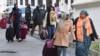 Des migrants se dirigent vers un vol de rapatriement, quittant la Tunisie pour leurs pays d'origine le 4 mars 2023.