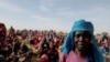 Halime Adam Moussa, a Sudanese refugee, waits with other refugees to receive a food portion from World Food Program in Koufroun, Chad, near the border between Sudan and Chad, May 9, 2023. 