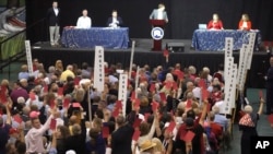 Delegates raise red cards to object to a proposal being debated at the South Carolina Republican Party State Convention at River Bluff High School in Lexington, South Carolina, May 20, 2023.