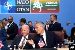 FILE - NATO Secretary General Jens Stoltenberg, right, speaks with United States President Joe Biden during a meeting of the NATO-Ukraine Council during a NATO summit in Vilnius, Lithuania, July 12, 2023.