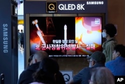 A news program broadcasts file images of a rocket launch by North Korea, at the Seoul Railway Station in Seoul, South Korea, May 28, 2024. A rocket launched by North Korea to deploy the country's second spy satellite exploded shortly after liftoff on May 27, state media reported.