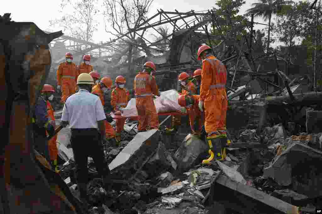 National Disaster Response Force rescuers carry the dead body of a person after an explosion and fire at a chemical factory in Dombivali near Mumbai, India.