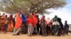 (FILE) Internally displaced Ethiopians queue to receive food aid in a camp for people displaced by drought.