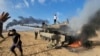 FILE — Palestinians celebrate by a destroyed Israeli tank at the Gaza Strip fence, Oct. 7, 2023. As images of the Israel-Hamas war circulated around the world, people in Rome commemorated the Nazi roundup of Rome's Jewish community during World War II.