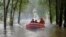 Rescuers ride a rubber boat and head to a village to carry out evacuation operation in the flood-hit Zhuozhou in northern China's Hebei province, Aug. 3, 2023. (Xinhua News Agency via AP)