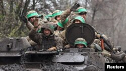 Ukrainian servicemen return from heavy fighting close to Bakhmut, Ukraine, April 15, 2023.