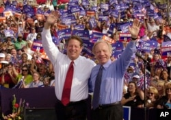 FILE - Democratic presidential candidate Vice President Al Gore, left, and his running mate, vice presidential candidate Sen. Joe Lieberman, of Connecticut, wave to supporters at a campaign rally in Jackson, Tenn., Oct. 25, 2000.
