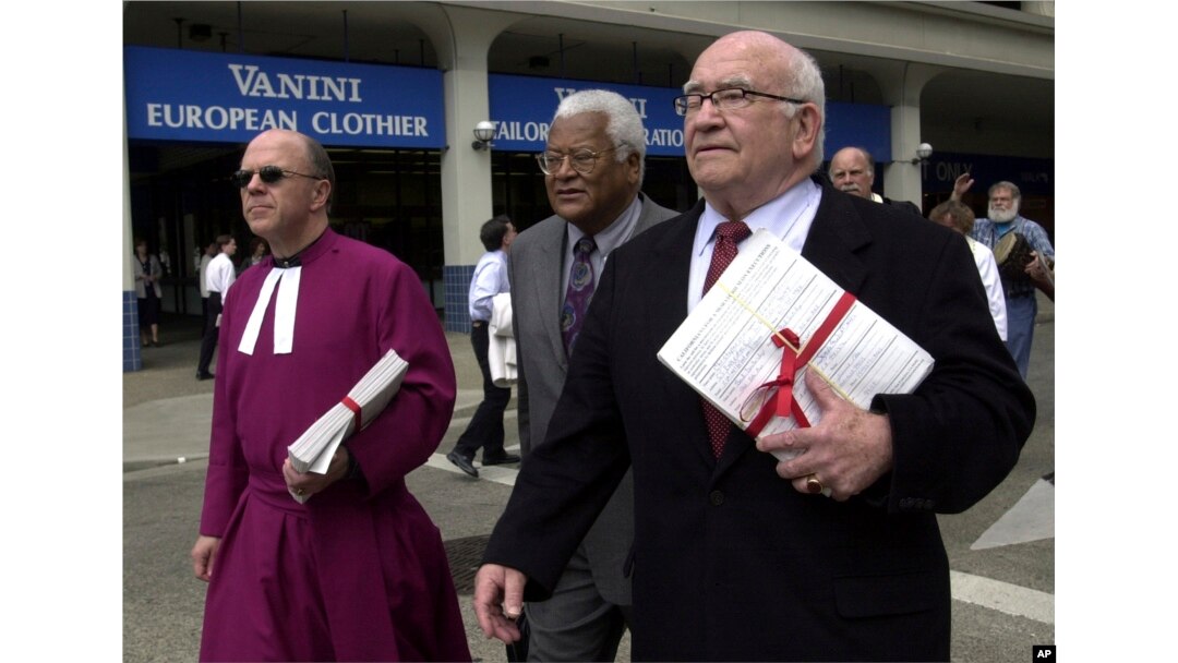 FILE - Actor Ed Asner, right, along with the Rev. Don Brown, left, and the Rev. James Lawson, center, walk to the Capitol, in Sacramento, Calif. carrying petitions calling for a "time out" of the death penalty, May 1, 2002.