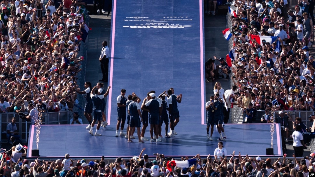 Athletes celebrate at the Champions Park, seen from the Eiffel Tower, at the 2024 Summer Olympics, in Paris, France, July 29, 2024.