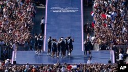 Athletes celebrate at the Champions Park, seen from the Eiffel Tower, at the 2024 Summer Olympics, in Paris, France, July 29, 2024.