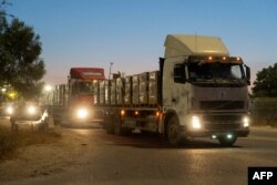 FILE — This photo eleased by the Israeli army on April 12, 2024, shows trucks carrying humanitarian aid preparing to enter the Gaza Strip amid continuing battles between Israel and the Palestinian militant group Hamas.