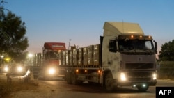 This handout picture released by the Israeli army on April 12, 2024, shows trucks carrying humanitarian aid preparing to enter the Gaza Strip amid continuing battles between Israel and the Palestinian militant group Hamas. 